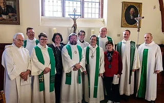 Group of people in church attire.